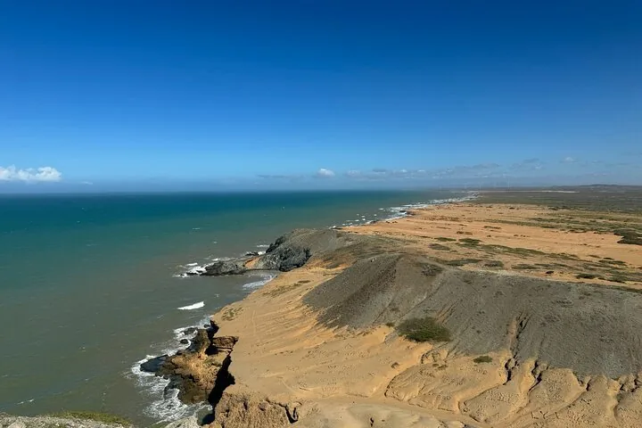 Aerial view of a rugged coastline meeting the ocean in Punta Gallinas